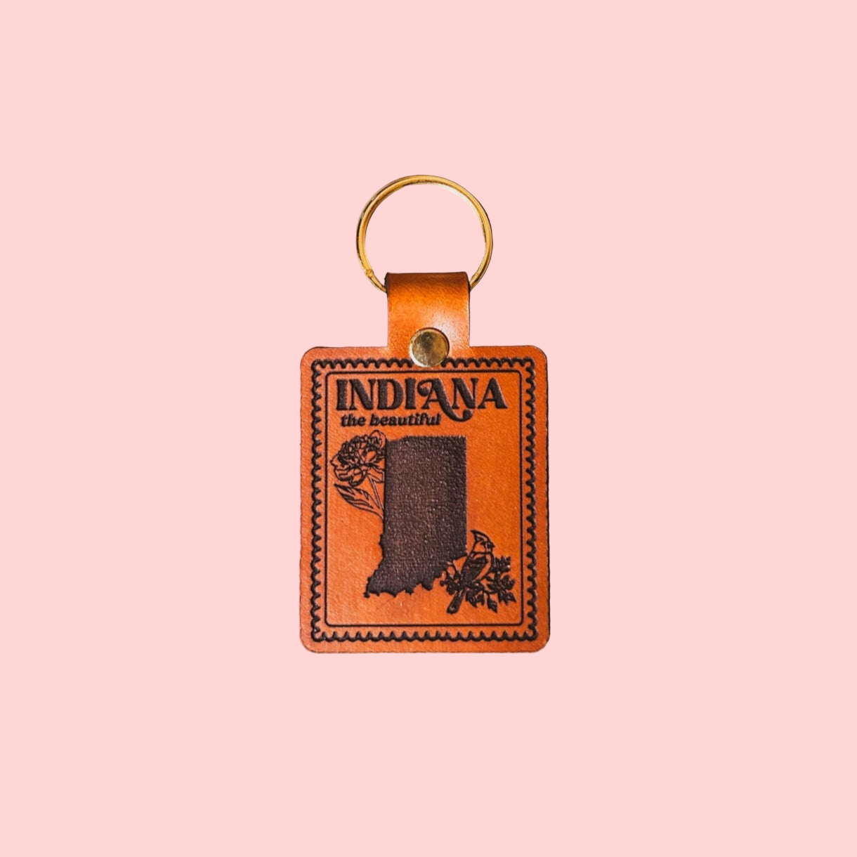 Leather keychain with 'Indiana the Beautiful' design on a pink background