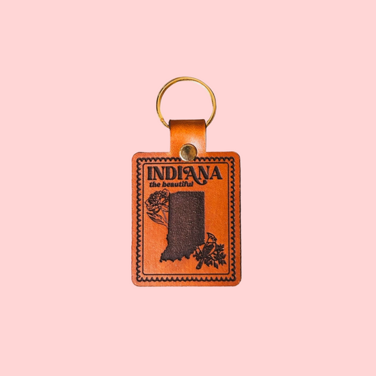 Leather keychain with 'Indiana the Beautiful' design on a pink background