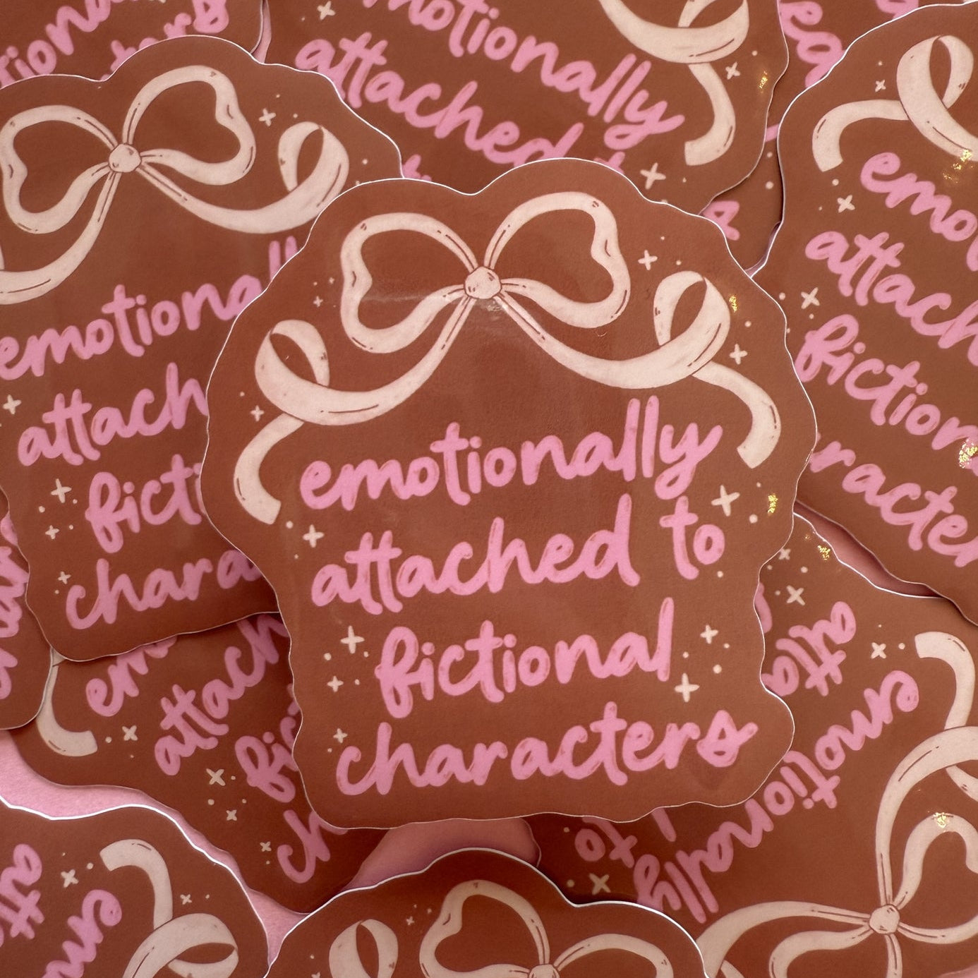 Stickers with decorative bows and text on a pink background