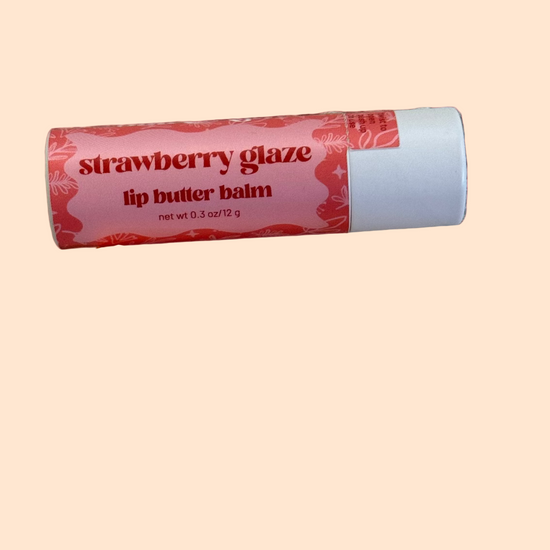 Lip butter balm with 'Strawberry Glaze' label on a pink background