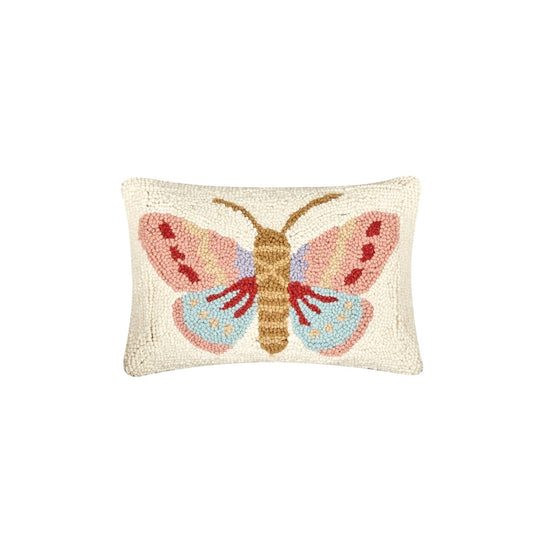 Decorative pillow with a colorful moth design on a white background
