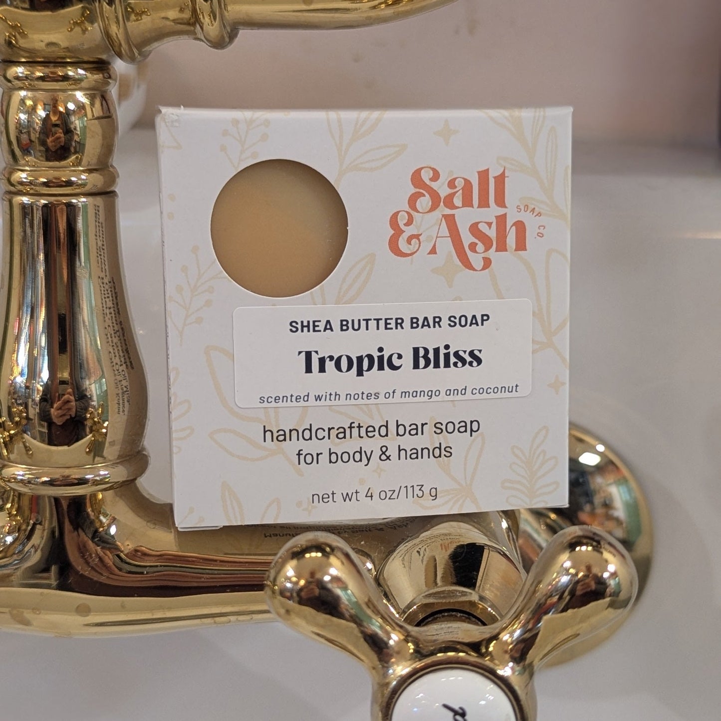 Salt & Ash Tropic Bliss bar soap on a gold soap dish with a white background
